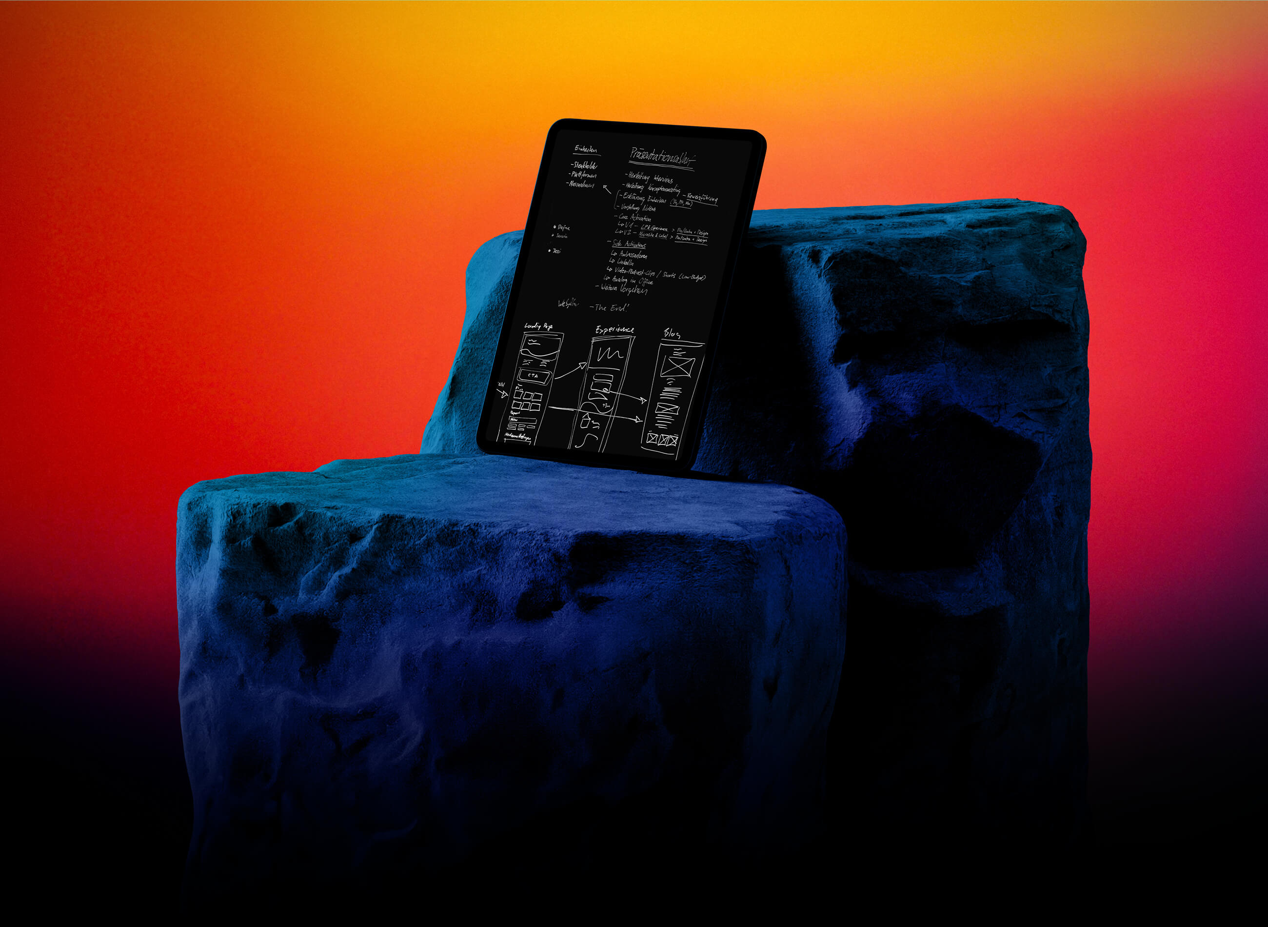 Tablet computer with handwritten notes lies on a stone